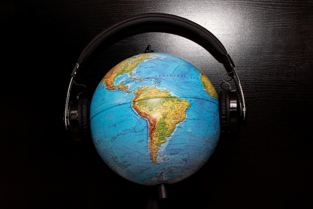 Photo globe in headphones on a black background