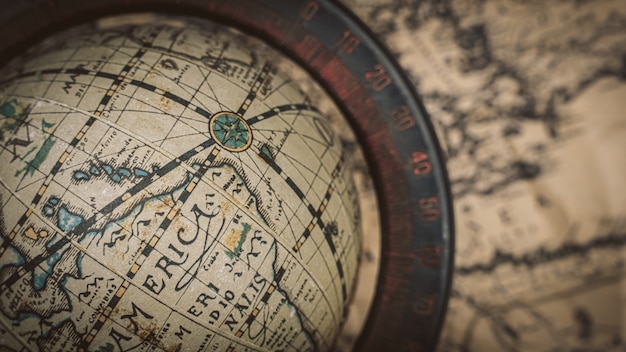 Globe model on old world map