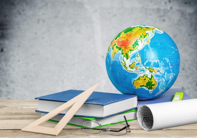 Photo globe, notebook stack and pencils. schoolchild and student studies accessories.