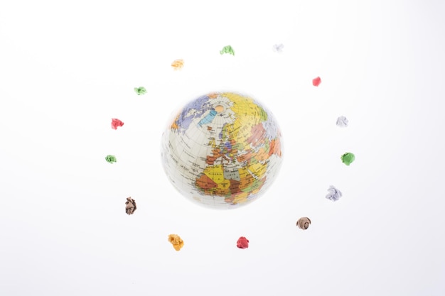 globe orbit and crumpled papers