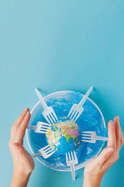 Globe on a plastic plate on blue background