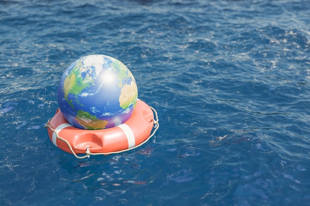 Globe with continents on round red lifebuoy floating on sea with clear and rippling water in nature on summer day 3d rendering