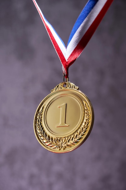 Glod medal against gray background