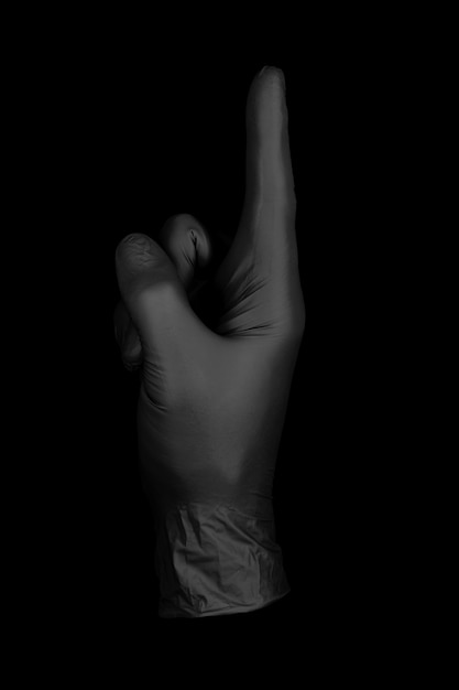 Перчатка черная указывая жест / изолированная перчатка черный фон