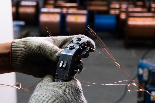 Gloved hands connect the copper cable to the core with a
special tool