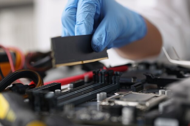 Gloved technician diagnoses broken computer equipment repair service concept