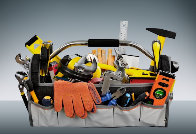 Gloves and tools on wooden background