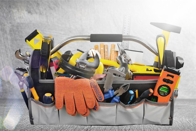 Gloves and work tools on stone background