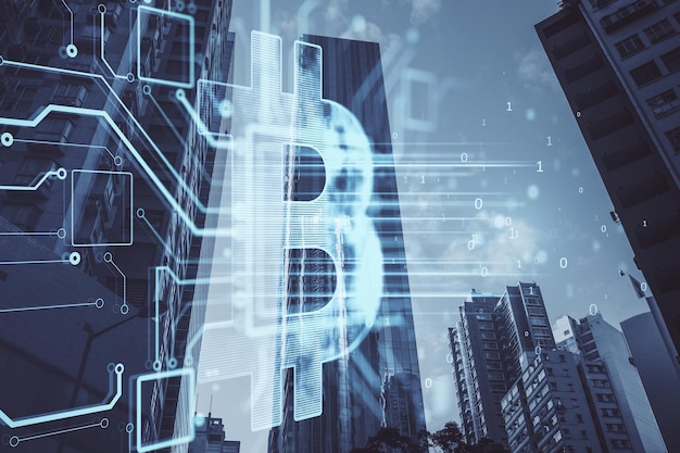 Glowing bitcoin hologram on blurry city background Metaverse cryptocurrency and crypto concept Double exposure