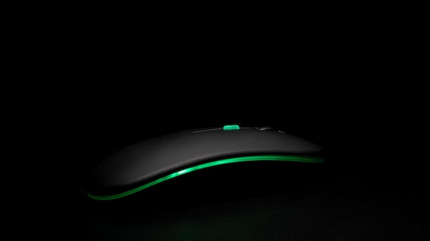 glowing black computer mouse in the dark