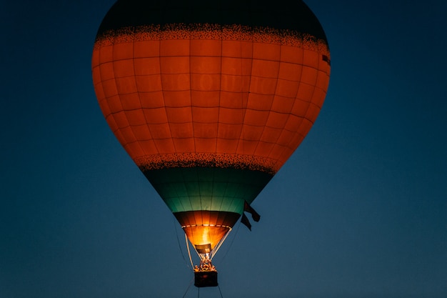 Glowing and blinking balloon flight with people in night sky