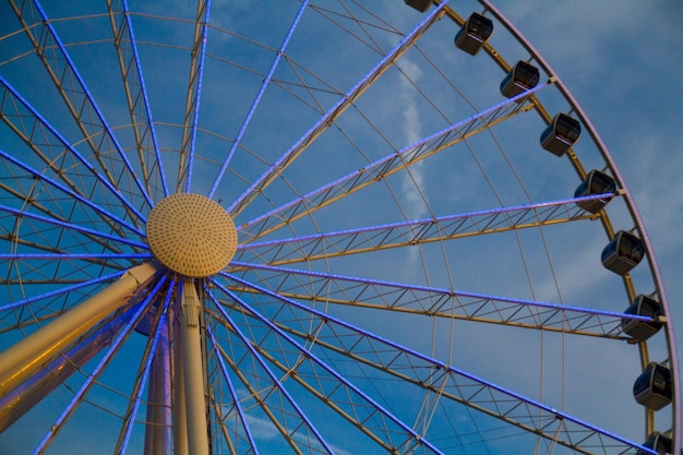 Glowing Blue Ferris Wheel Against Cloudy Sky in Gatlinburg Tennessee