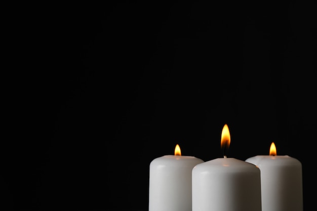 Glowing candles on black, space for text