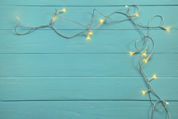 Glowing Christmas tree garland on table