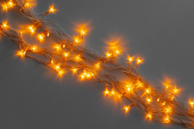 Glowing golden electric garland on a gray 