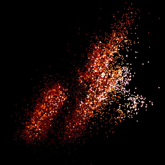 Glowing golden glitter scattered on a black background