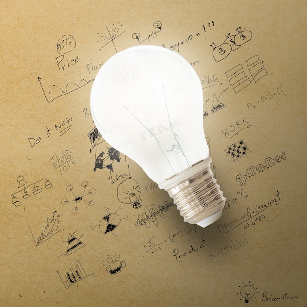 Glowing Light bulb on the drawing of business strategy plan. 