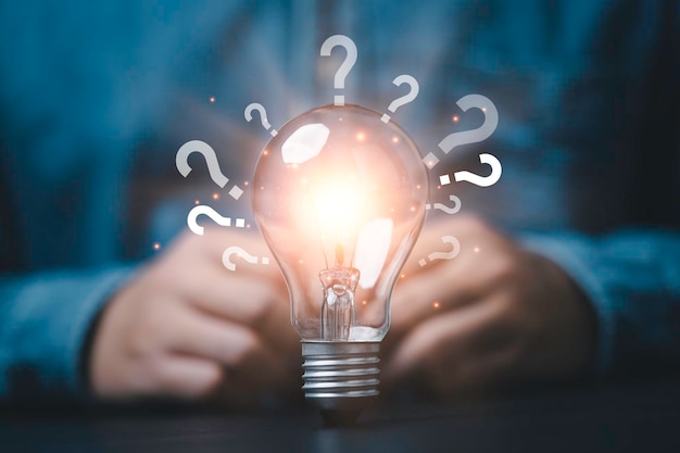 Glowing lightbulb and question mark with copy space for creative thinking idea and problem solving concept