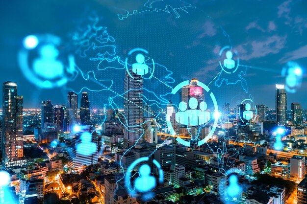 Glowing Social media icons on night panoramic city view of Bangkok Asia The concept of networking and establishing new connections between people and businesses Double exposure