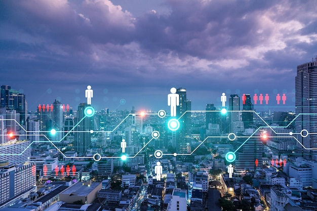 Glowing Social media icons on night panoramic city view of Bangkok Asia The concept of networking and establishing new connections between people and businesses Double exposure