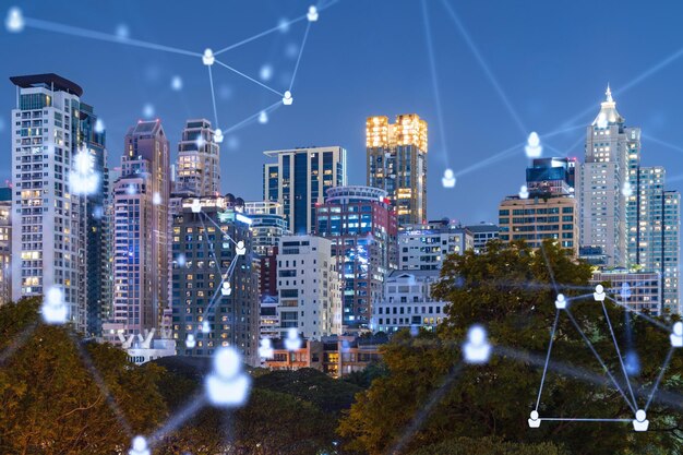 Glowing social media icons on night panoramic city view of Bangkok Southeast Asia The concept of networking and establishing new connections between people in businesses Double exposure