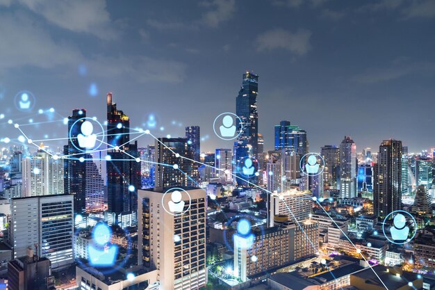 Glowing social media icons on night panoramic city view of Bangkok Southeast Asia The concept of networking and establishing new connections between people in businesses Double exposure