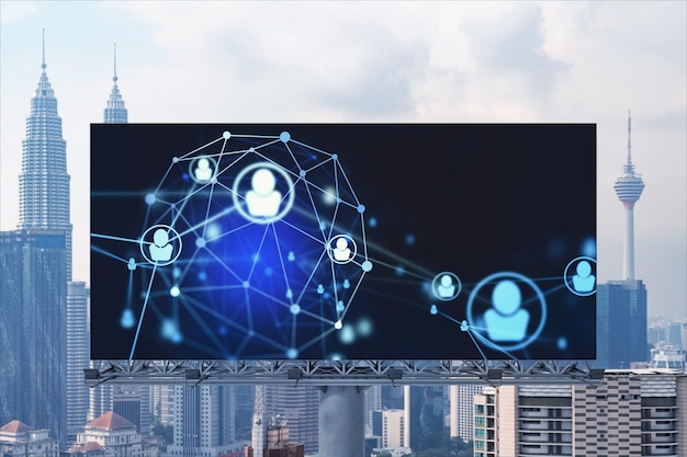 Glowing Social media icons on road billboard over panoramic city view of Kuala Lumpur Malaysia Asia The concept of networking and establishing new connections between people and businesses in KL