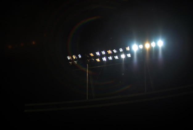 Glowing stadium lights against in the night