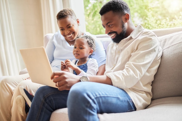 Glued to the laptop screen. Shot of a family using a laptop together at home.