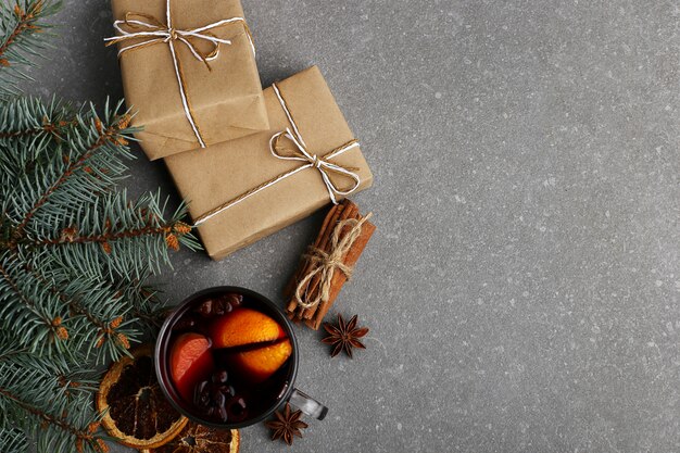 Glühwein, een geschenk en specerijen op de tafel naast de boom