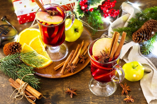 Glühwein in glazen mok met kruiden op rustieke tafel winterkerst warme drank met oranje appel