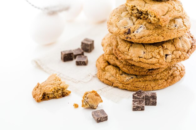 Gluten free chocolate chunk cookies with glass of milk.