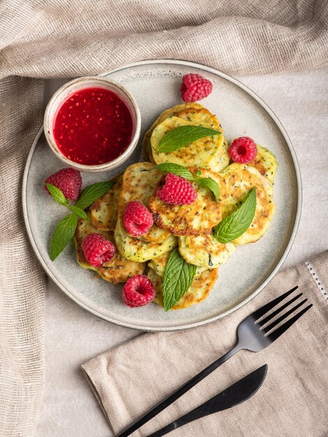 Gluten-free zucchini pancakes with raspberries and raspberry jam. Healthy food concept, summer food.