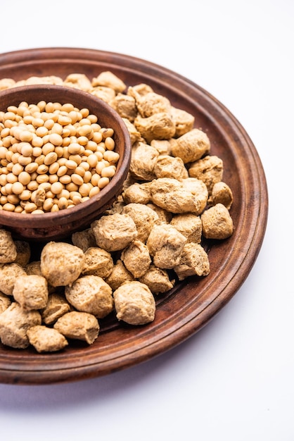 Glycine max or Soya bean or uncooked soybean chunks. Served in a bowl or as a Pile. selective focus