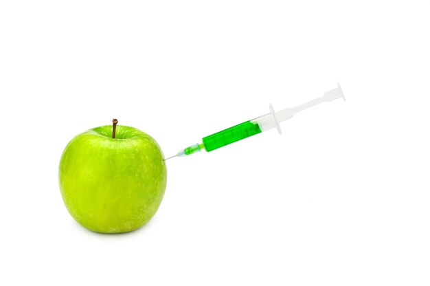 GMO apple with syringe on the white