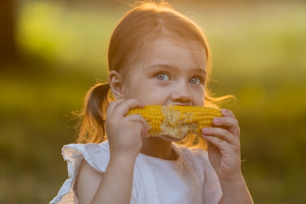 GMO 무료 식품 아이들은 야외에서 과일을 먹습니다. 어린이 여름 컨셉을 위한 건강한 간식