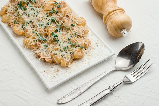 Gnocchi on a white background with flour