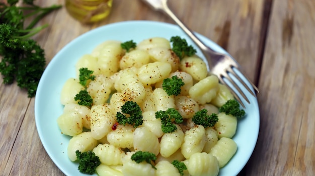 Gnocchi with olive oil and spices on a plate.