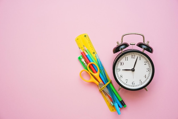 Go back to school college or university Office supplies on a pink background