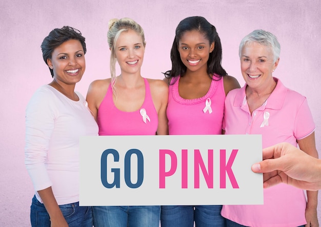 Go Pink Text and Hand holding card with pink breast cancer awareness women