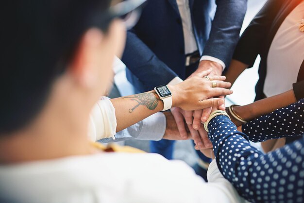 Photo go team high angle shot of a group of coworkers hands in a huddle