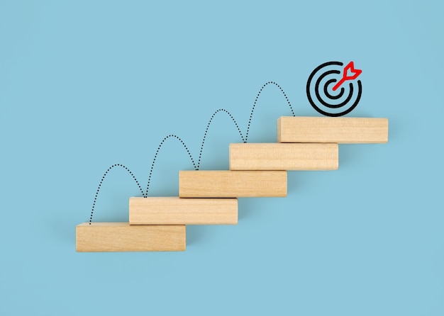 Goal Target, Action, Plan, Idea, Inspiration Concept, wooden block staircase with target icon.