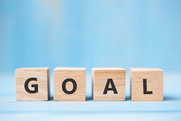 GOAL wooden cubes on blue table background 