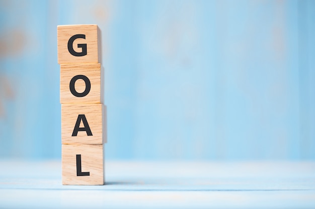 GOAL wooden cubes on blue table background 