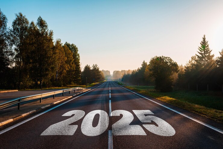 Фотография слово "календарь целей 2025" написано на шоссе посреди пустой асфальтированной дороги при золотом закате и красивом голубом небе концепция на 2025 год
