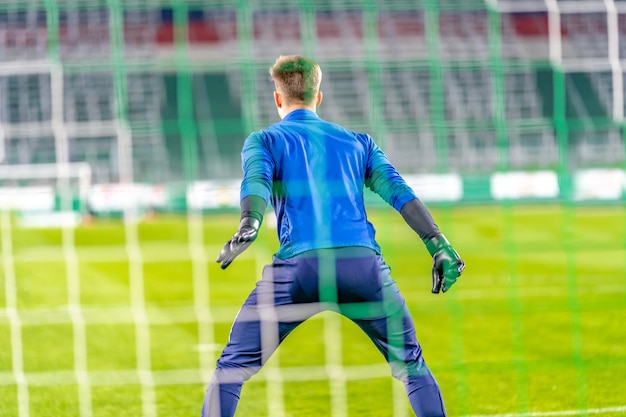 Goalkeeper catches the ball in the goal in a soccer match