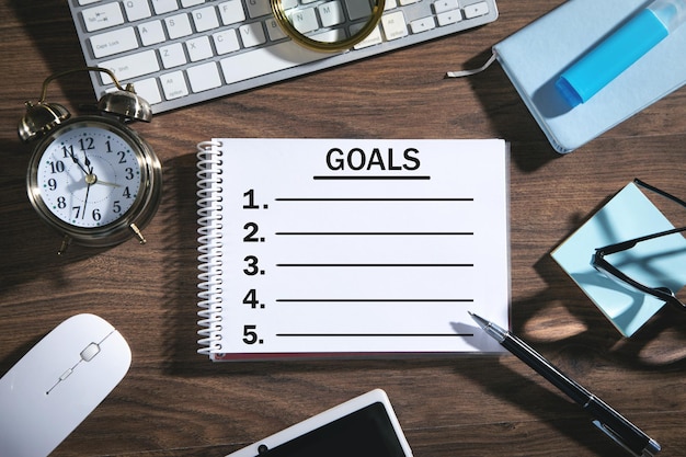 Goals list on notepad with a business objects.