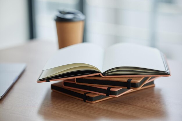 Goals should be written Shot of a stack of books in a table in a modern office