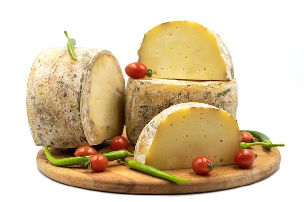 Goat cheddar cheese isolated on a white background close up