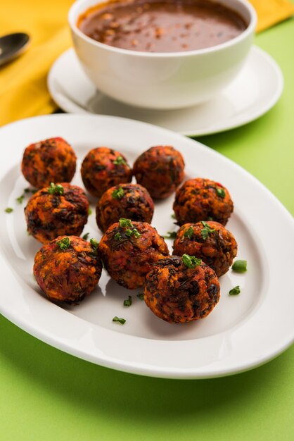 Gobi Manchurian dry or with gravy - Popular street food of India made of cauliflower florets, selective focus